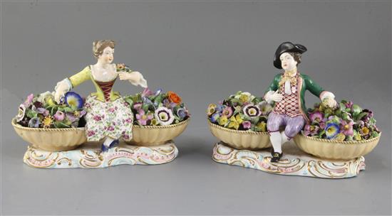 A pair of Minton figures with baskets, c.1840, width 19.5cm, some restoration
